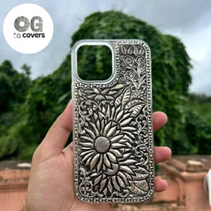 Silver mobile cover with intricate engraved floral and flower design, premium metallic finish luxury phone case for iPhone showcasing detailed handcrafted artwork and elegant silver texture.